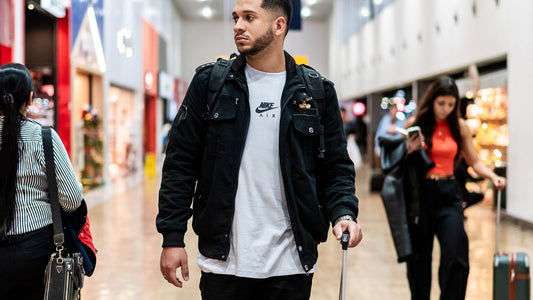 Traveler pulling a suitcase through a modern airport terminal