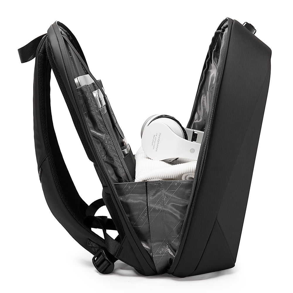 Open black backpack with organized interior holding white headphones, clothes, and tech accessories.