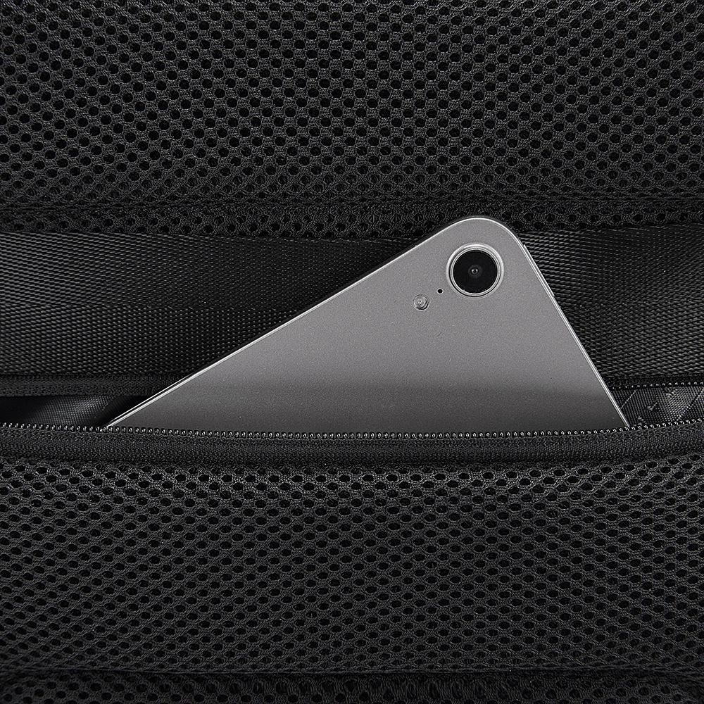Close-up of tablet in hidden mesh zip pocket on anti-theft backpack with padded back panel.