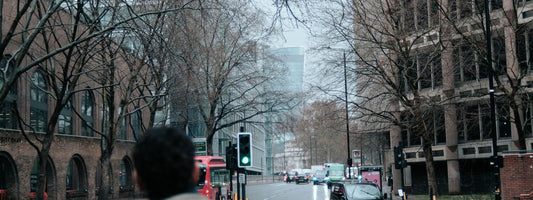 Person with a backpack on a wet city street