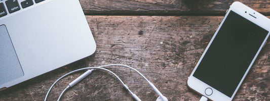 Laptop, phone and tech accessories arranged on a table