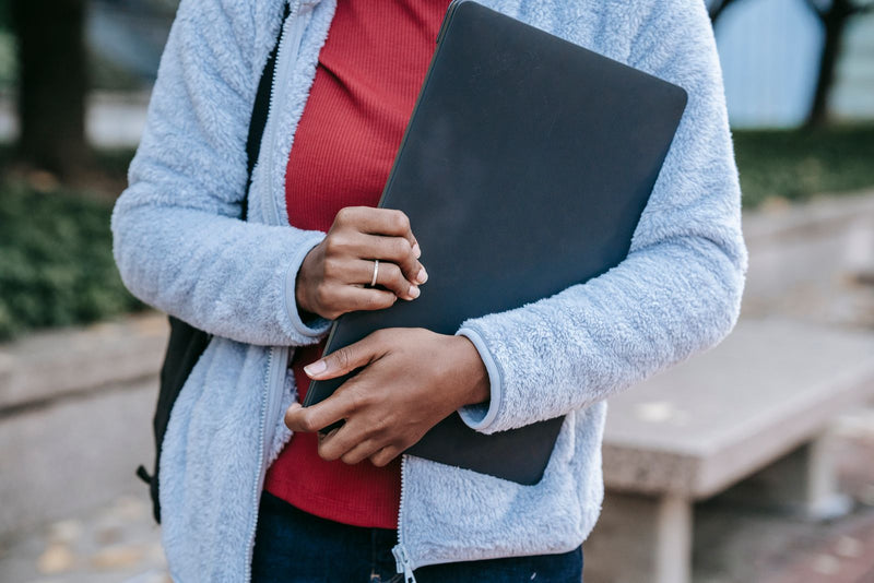 Woman sitting outdoors in a park working on a laptop