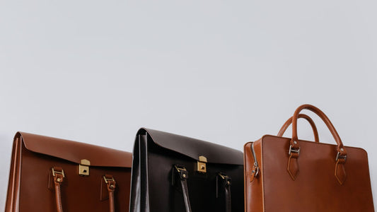 Close-up of brown and black leather bags showing rich leather grain and stitching