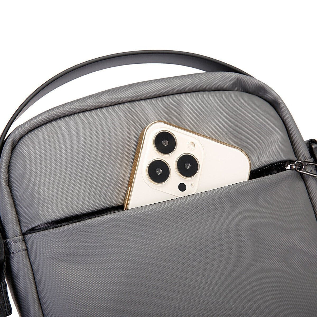 Close-up of Nytra BANGE 2876 gray sling bag's back pocket with smartphone partially inserted for easy access.