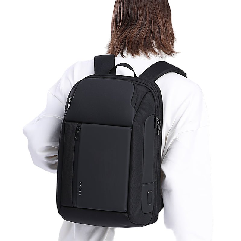 Person carrying BANGE TRENZA 7663 black laptop backpack on the back on a white background